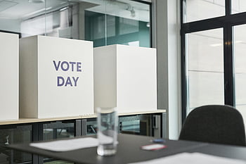 vote day, voting booths, modern office, election activity, big boxes, sign, standing on table, office setting, election day, voting day, office environment