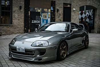 toyota supra, zaparkované na chodníku, město chodník, sportovní eleganci, luxusní auto, stříbrné auto, městském prostředí, fotografování automobilů, parkování na ulici, Supra Car