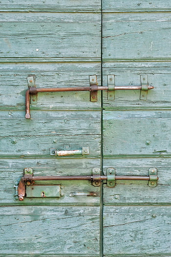 old wooden door, rusted iron locks, vintage charm, rustic texture, brown steel latches, antique door, weathered wood, metal hardware, aged locks, rural aesthetic, historical architecture