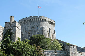 Windsor Castle, stone tower, Union Jack, clear blue sky, gray concrete castle, flag on top, historic architecture, British landmark, medieval castle, England, United Kingdom
