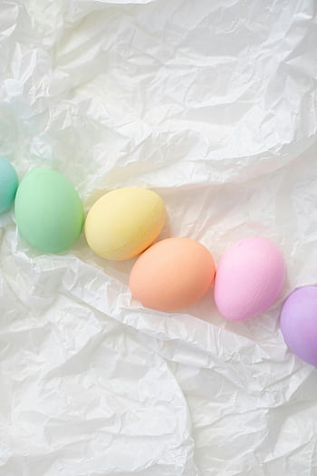 Easter eggs, pastel colors, decorative eggs, holiday themes, crumpled white background, assorted colored eggs, Easter decorations, pastel Easter eggs, holiday decor, Easter egg arrangement, Easter egg display