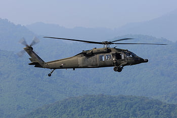 grey flying helicopter, military helicopter, powerful rotors, scenic mountain backdrop, in flight, aerial view, military aircraft, helicopter flight, mountain landscape, military operation, black helicopter