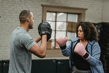 black woman, boxing training, ethnic personal instructor, focused female boxer, male coach, gym, strength, determination, boxing gloves, training session, fitness
