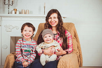 mother, two children, cozy home, joyful picture, baby, boy, sitting beside, carrying baby, home setting, fireplace