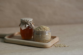 brown grains, clear glass jar, honey, quinoa, natural ingredients, close-up, glass jars, wooden tray, healthy food, organic, rustic setting