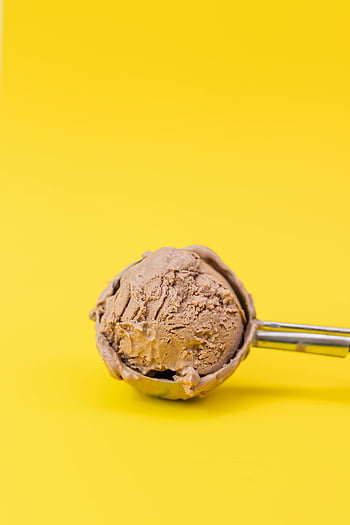 chocolate ice cream, scoop, dessert, yellow background, delicious, ice cream scoop, bright yellow, chocolate flavor, frozen treat, creamy texture, dessert inspiration
