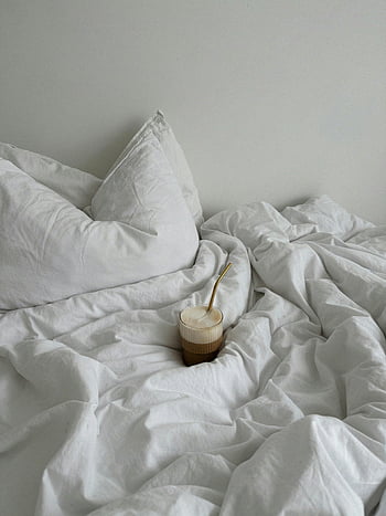 coffee in bed, cozy bedroom, white linen sheets, relaxation, glass of coffee, morning coffee, bed with coffee, white bedding, comfortable bed, bedroom ambiance, coffee relaxation