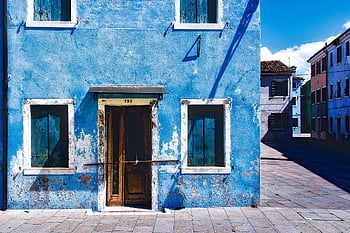 blue building, rustic architecture, wooden windows, bright daylight, empty street, old house, blue concrete, 2-storey house, street scene, Mediterranean style, weathered facade