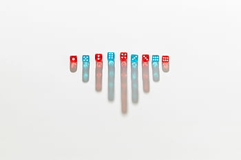 blue dice, red dice, symmetric arrangement, elongated shadows, white surface, game pieces, dice photography, colorful dice, dice shadows, dice pattern, dice art
