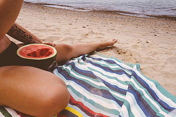 beach, watermelon, sunny day, relaxation, person eating, beach towel, sand, ocean, summer, outdoor, vacation