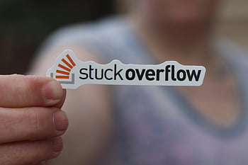 stuck overflow, coding humor, close-up hand, paper cutout, brand name, logo, sticker, programming joke, tech humor, software developer, tech culture