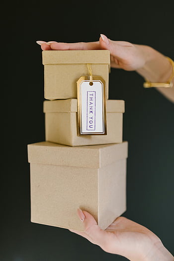 kraft gift boxes, stacked boxes, thank you tag, woman's hands, brown wooden box, gift packaging, gift presentation, thank you note, gift box stack, gift wrapping, gift box set
