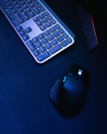 cordless mouse, wireless keyboard, modern tech design, dark surface, close-up, computer peripherals, ergonomic mouse, sleek design, technology gadgets, office setup, desk accessories