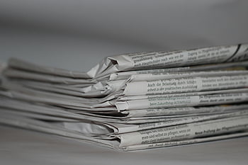 folded newspapers, close-up newspapers, news themes, journalism themes, stacked newspapers, printed newspapers, media content, press industry, daily news, newsprint stack, news articles