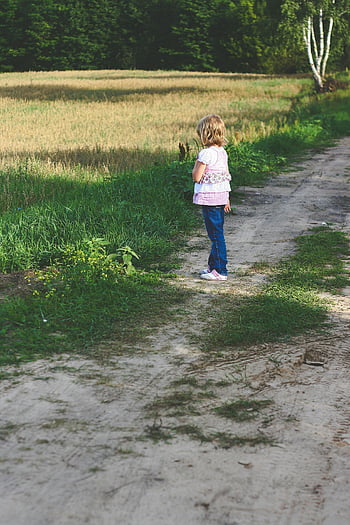 little girl, dirt path, sunny day, childhood exploration, young girl walking, field, outdoor scene, rural setting, nature, summer day, girl outdoors