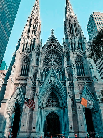 St. Patrick's Cathedral, NYC, Gothic architecture, majestic facade, cathedral, New York City, religious building, historic landmark, American flag, architectural details, urban cathedral