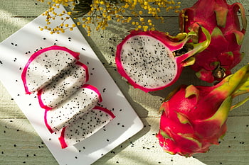 dragon fruit, sliced dragon fruit, ceramic plate, tropical freshness, healthy eating, vibrant dragon fruit, wood background, dragon fruit slices, tropical fruit, healthy snack, dragon fruit plate