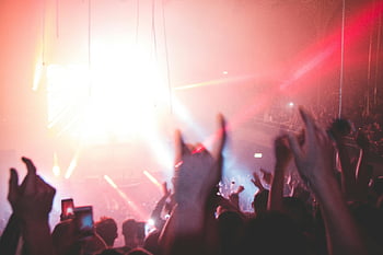 concert, people having fun, lively nightclub, crowd enjoying, vibrant lights, energetic music, nightlife, party atmosphere, music event, entertainment, nightlife scene