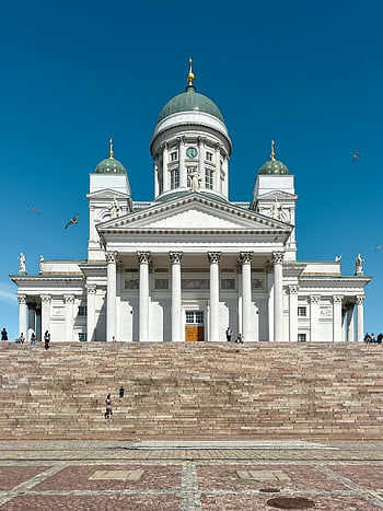 Helsinki Cathedral, sunlit view, clear blue sky, iconic landmark, white columns, dome structure, Finnish architecture, outdoor scene, sunny day, tourist attraction, Helsinki Finland