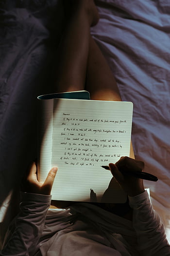 woman writing, notebook, pen, cozy bedroom, dimly lit, relaxing, comfortable, home, personal journal, lap, writing session