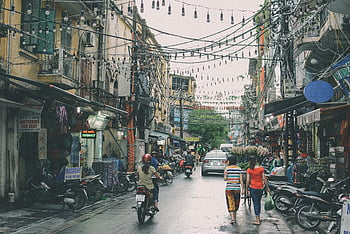 Hanoi, Đống Đa district, vibrant street scene, bustling markets, motorbikes, street life, urban scene, Vietnamese culture, cityscape, daily life, street photography