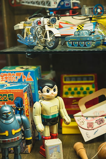vintage Japanese toys, plastic toys, robots, bikes, tanks, retail setting, showcase, toy shop, retro toys, collectibles, toy shelves