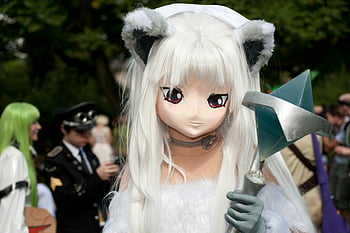 anime character, cosplay, unique costume, outdoor convention, striking character, white wig, cat ears, cosplay event, convention setting, anime cosplay, cosplay outfit