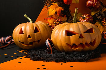 Jack-o-lanterns, carved pumpkins, spooky faces, autumnal background, Halloween, orange pumpkins, festive decorations, seasonal display, fall decor, holiday theme, carved faces