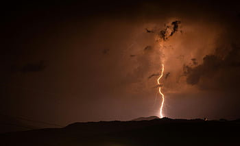 lightning strike, mountain, night sky, thunderstorm, illuminated, silhouetted mountains, bolt of lightning, striking bolt, natural phenomenon, stormy weather, night scene