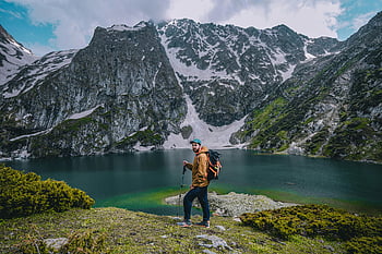man hiking, scenic mountain lake, natural beauty, adventure, outdoor activities, mountain landscape, hiking gear, adventure travel, nature photography, scenic views, mountain adventure