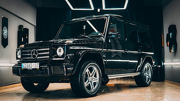 Mercedes, black Mercedes SUV, modern indoor setting, elegant car, luxury vehicle, indoor car display, Mercedes G-Class, high-end automobile, sleek design, indoor showroom, black SUV