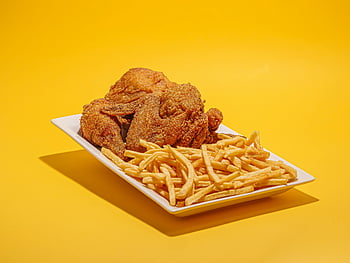 fried chicken, french fries, crispy fries, vibrant yellow background, delicious food, plate of chicken, plate of fries, fried chicken and fries, yellow background, food photography, meal presentation