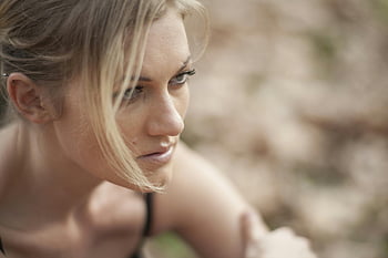focus photography, woman, blonde hair, serene, outdoors, soft lighting, dreamy mood, close-up, young woman, natural light, portrait