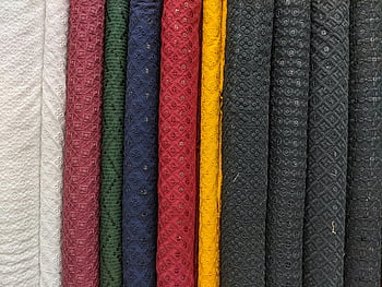 colorful fabrics, intricate patterns, textured fabric, close-up view, fabric rolls, multicolored textiles, textured designs, patterned textiles, fabric patterns