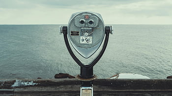 coin operated viewer, vintage viewer, ocean view, cloudy day, seaside attraction, tower viewer, close-up photo, vintage coin viewer, ocean scenery, seaside viewer, coin viewer