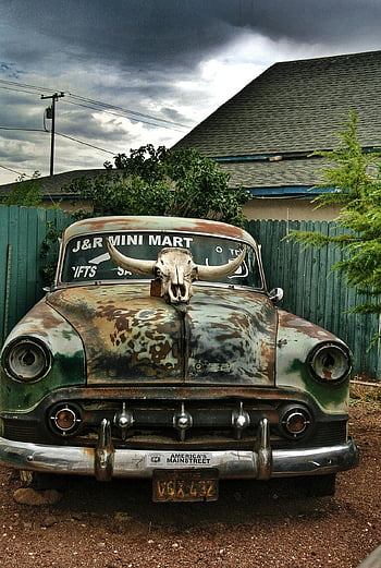 cow skull, rusty vintage car, Seligman AZ, vehicle hood, white animal skull, America's Mainstreet, J&R Mini Mart, rusty car, vintage vehicle, cow skull decoration, Seligman Arizona