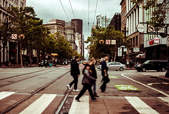 pedestrians crossing, busy intersection, downtown San Francisco, cloudy day, city street, urban scene, crosswalk, traffic, city life, people walking, street view