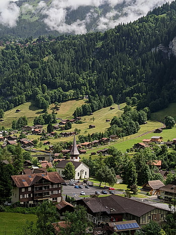 Lauterbrunnen, Switzerland, lush green valley, village, mountains, stunning view, Swiss Alps, Swiss village, natural landscape, travel destination, scenic beauty