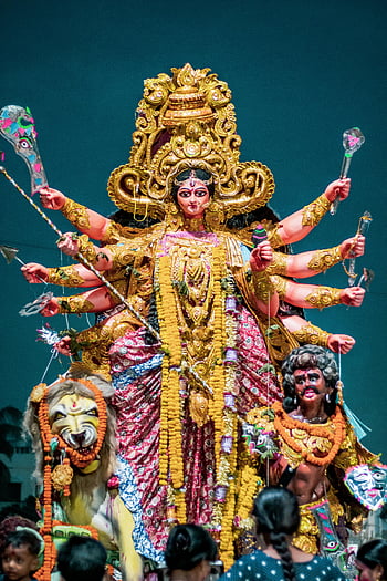Hindu goddess Durga, colorful statue, intricate design, Indian cultural festival, brightly adorned, golden statue, cultural display, traditional art, religious icon, festival celebration, goddess Durga statue