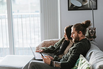 couple, browsing internet, smartphone, laptop, couch, indoors, pet cat, quality time, online together, young couple, living room