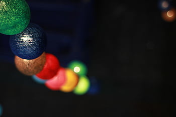 Green Blue and Brown Multicolored Ball Ornament, colorful string lights, vibrant atmosphere, night scene, multicolored balls, decorative lights, festive lighting, outdoor lighting, holiday decor, bokeh effect, night photography