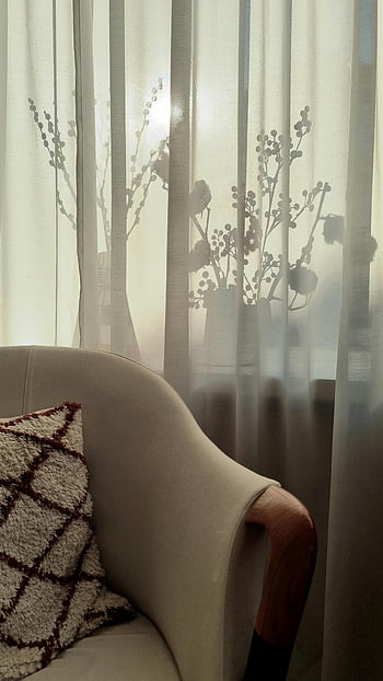 cozy armchair, window, white tulle curtain, warm interior, floral silhouettes, sheer curtains, tranquility, home decor, living room, soft lighting, comfortable seating