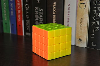 cube 4x4x4, Rubik's cube, puzzle cube, colorful cube, 4x4 cube, brain teaser, bookshelf, wooden surface, close-up, toy cube, solving cube