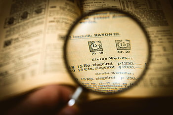 close-up text, book page, magnifying glass, text clarity, detailed view, magnified text, book reading, vintage book, text enhancement, reading aid, magnification