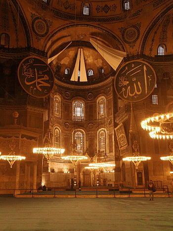 Hagia Sophia, Istanbul, warm-lit interior, grand chandeliers, mosque architecture, religious building, historical landmark, Turkish culture, interior design, Islamic art, domed ceiling