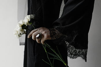 woman in black dress, white flowers, mourning, elegance, black lace dress, close-up, holding flowers, symbolizing mourning, elegant woman, black dress, white blooms