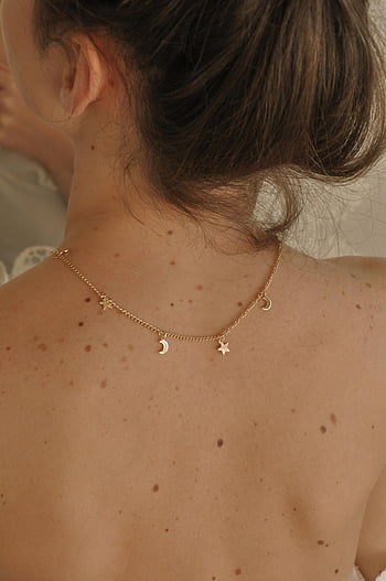 woman, elegant necklace, bare back, delicate gold necklace, enhancing elegance, femininity, back view, gold chain, star charm, moon charm, bare shoulders