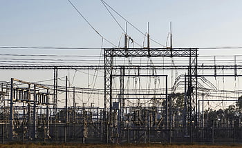 power distribution substation, high-voltage electrical substation, steel structures, power lines, dawn, electrical infrastructure, energy distribution, utility infrastructure, substation equipment, electrical grid, power transmission