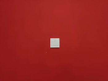 white square light switch, red wall, minimalist design, bold red, simplicity, centered light switch, white switch, red background, modern design, wall switch, minimalist wall