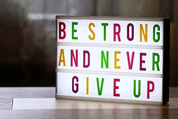 illuminated text box, motivational lightbox, Be Strong and Never Give Up, inspirational sign, colorful letters, motivational quote, lightbox display, motivational message, inspirational lightbox, motivational text, lightbox sign
